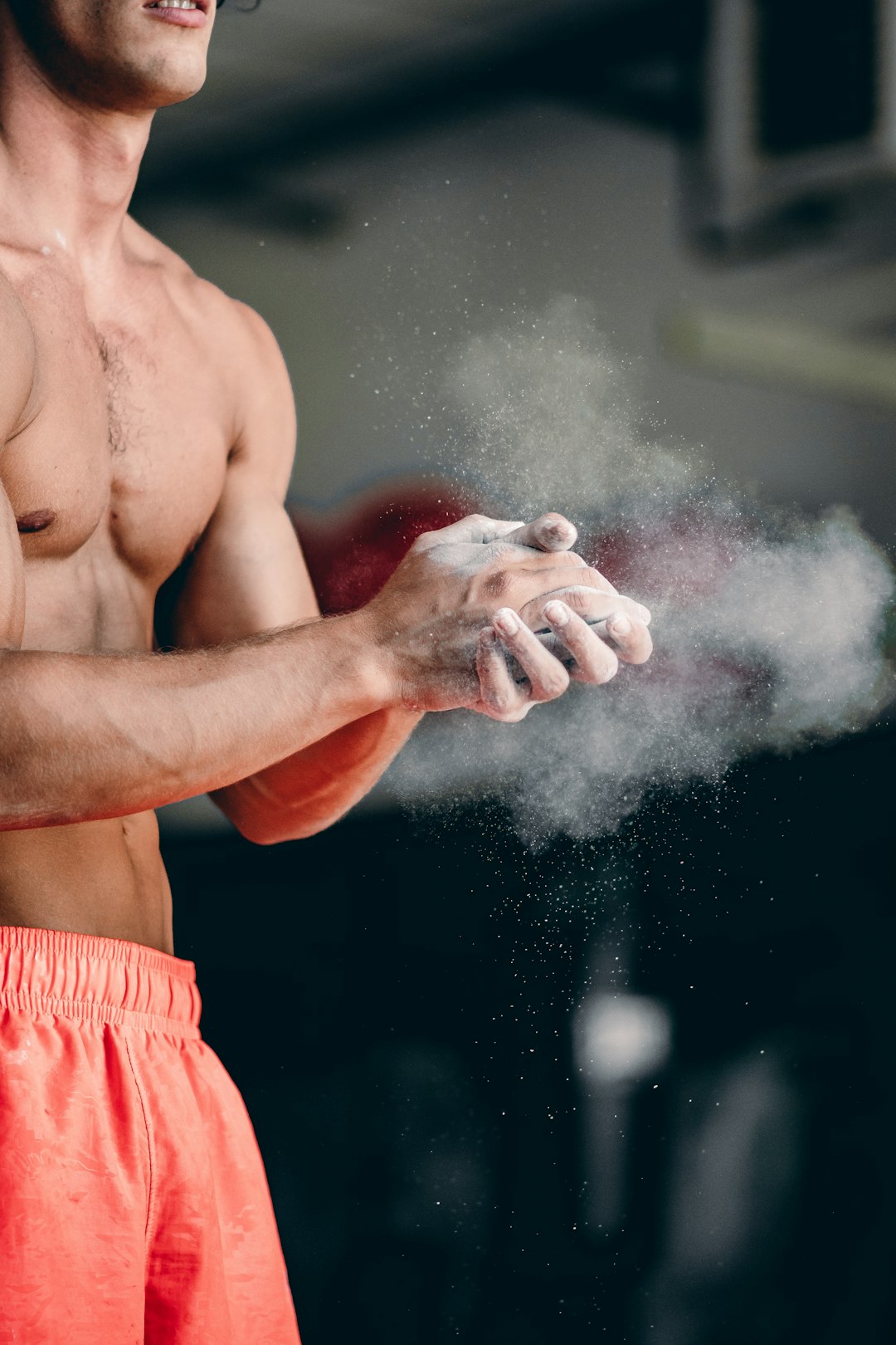 a-shirtless-man-holding-a-white-object-in-his-hand-swwe89ir5k8